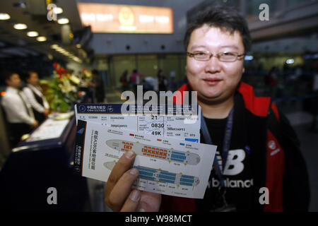 A passenger shows his ticket for the flight on Chinas first Airbus