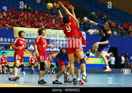 Players of Japan (Blue) and players of South Korea compete in a match during the Womens Handball Asian Qualification for 2012 Olympic Games in Changzh Stock Photo