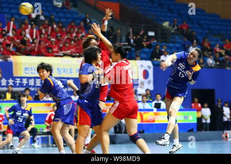 Players of Japan (Blue) and players of South Korea compete in a match during the Womens Handball Asian Qualification for 2012 Olympic Games in Changzh Stock Photo