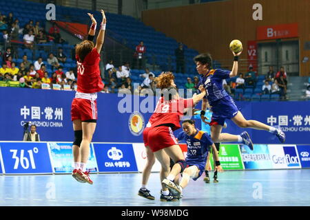 Players of Japan (Blue) and players of South Korea compete in a match during the Womens Handball Asian Qualification for 2012 Olympic Games in Changzh Stock Photo