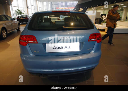 --FILE--A Chinese car buyer walks past the Audi A3 at an Audi dealership in Shanghai, China, 5 January 2011.   Audi, a luxury car unit of German autom Stock Photo