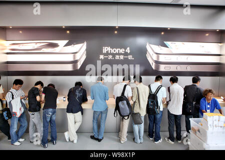 --File-- Chinese buyers try the iPhone 4 smartphones in the Apple Store in the Hong Kong Plaza in Shanghai, China, 25 September 2010.   Gao Jun arrive Stock Photo