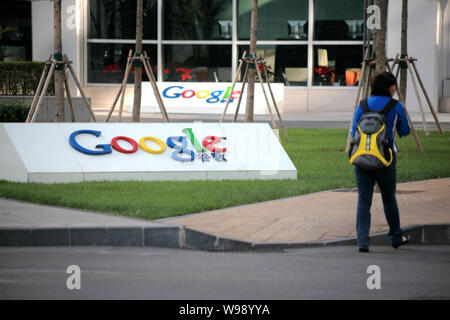 --FILE--A woman walks past the headquarters of Google China in Beijing, China, 3 October 2009.   US Internet search giant Google, which recently accus Stock Photo