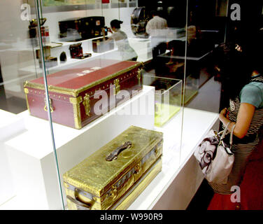 A visitor looks at handbags on display during the Louis Vuitton Voyages  exhibition at the National Museum of China in Beijing, China, 31 May 2011.  A Stock Photo - Alamy