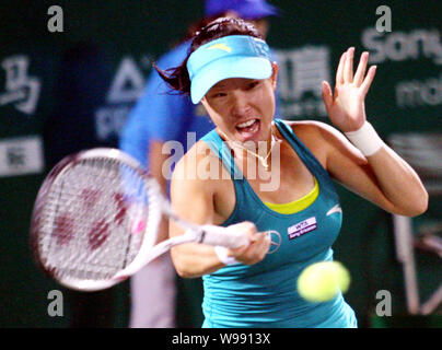 Zheng Jie of China returns a shot against Noppawan Lertcheewakarn of Thailand in their second round during the WTA Guangzhou International Womens Open Stock Photo