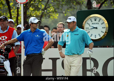 Lee Westwood of England, right, talks with Adam Scott of Australia in the first-day competition during the 2011 WGC-HSBC Champions golf tournament at Stock Photo