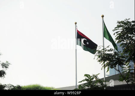 The flag of the Libyan transitional government flutters after the former Libyan national flag was lowered at the Embassy of Libya in Beijing, China, 2 Stock Photo