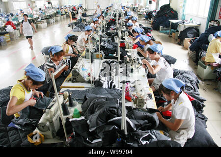 --File--Female Chinese workers sew clothes to be exported to southeast Asian countries at the garment factory of Huaibei Qiuyan Industrial And Trading Stock Photo