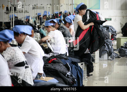 --File--Female Chinese workers sew clothes to be exported to southeast Asian countries at the garment factory of Huaibei Qiuyan Industrial And Trading Stock Photo