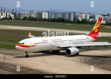 --FILE--An Airbus A330-300 jet plane of Hainan Airlines is pictured at Sanya Phoenix International Airport in Sanya city, south Chinas Hainan province Stock Photo
