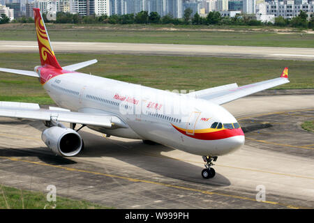 --FILE--An Airbus A330-300 jet plane of Hainan Airlines is pictured at Sanya Phoenix International Airport in Sanya city, south Chinas Hainan province Stock Photo