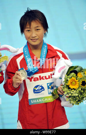 Chinas silver medalist Hu Yadan poses on the podium at the award ceremony for the womens 10-meter platform diving event during the 14th FINA World Cha