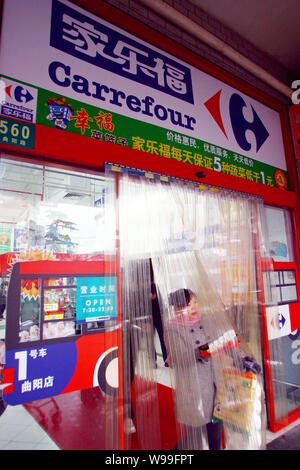 --FILE--A customer walks out from a Carrefour supermarket in Shanghai, China, 17 Febuary 2011.  Staff members of French retail giant Carrefour were fo Stock Photo