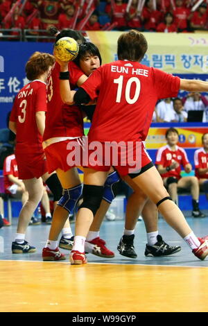 Players of Japan (Blue) and players of South Korea compete in a match during the Womens Handball Asian Qualification for 2012 Olympic Games in Changzh Stock Photo