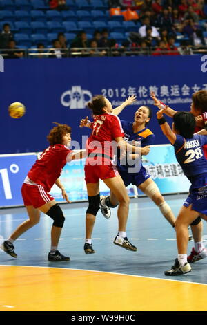 Players of Japan (Blue) and players of South Korea compete in a match during the Womens Handball Asian Qualification for 2012 Olympic Games in Changzh Stock Photo