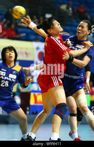 Players of Japan (Blue) and players of South Korea compete in a match during the Womens Handball Asian Qualification for 2012 Olympic Games in Changzh Stock Photo