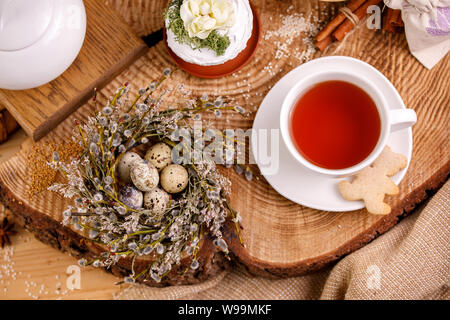 Easter composition with willow and willow lights with Easter eggs and traditional Easter cakes. Holiday concept.Easter still life. Stock Photo