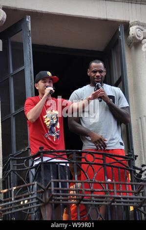 NBA star of Miami Heat LeBron James (R) is seen on a balcony of a century-old house during his China Tour in Shanghai, China, 17 August 2011. Stock Photo