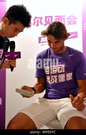 Spanish tennis player Rafael Nadal is interviewed during a fans meeting in Shanghai, China, 10 October 2011. Stock Photo