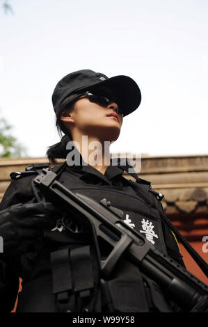 A Chinese special policewoman patrols a street in Chengdu city, southwest Chinas Sichuan province, 23 November 2011.   A female special police team st Stock Photo