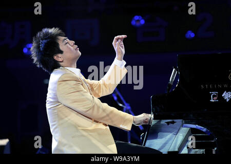 Chinese pianist Lang Lang performs during his New Year concert in Wuhan city, central Chinas Hubei Province, December 24, 2010. Stock Photo