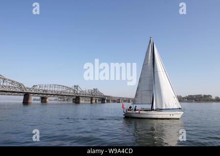 --FILE-- A sailing boat is seen in the Yalu River in Dandong, northeast Chinas Liaoning province, October 26, 2009.   China and the Democratic Peoples Stock Photo