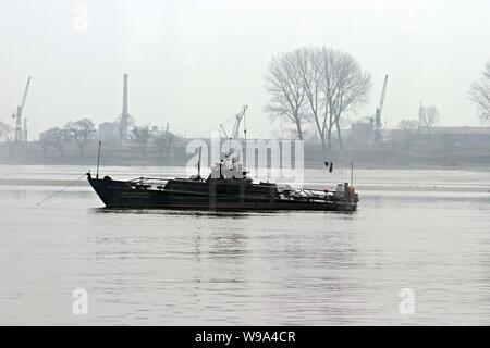 --FILE-- A boat is seen in the middle of the Yalu River in Dandong, northeast Chinas Liaoning province, April 4, 2009.   China and the Democratic Peop Stock Photo