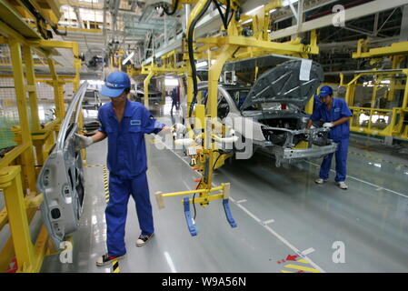 --FILE--Chinese workers assemble cars on the assembly line at the auto ...
