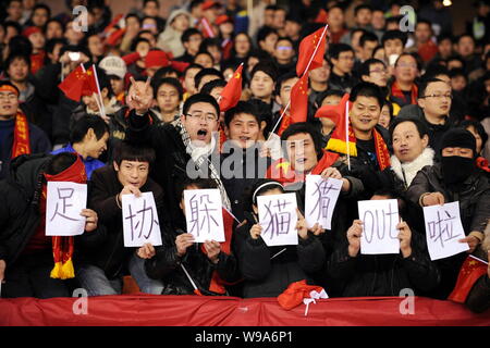 Chinese soccer fans show signs meaning It Has Been Out For Chinese Football Association to Hide, to taunt Chinese Football Association while Chinese a Stock Photo