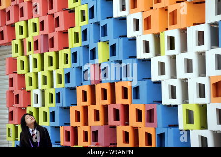 A visitor walks past PVC boxes at the Serbia Pavilion in the Expo site in Shanghai, China, 27 April 2010.   After receiving more than one million visi Stock Photo