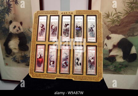 A set of 10 panda-themed silver bars for the World Expo 2010 are seen in front of paintings of the 10 Expo pandas during a launch ceremony in Shanghai Stock Photo