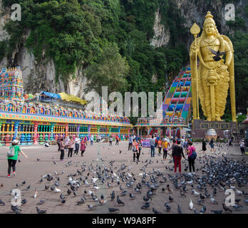 The giant, gold statue of Lord Murugan dominates the stairway entrance to Batu Caves in Kuala Lumpur, Malaysia Stock Photo