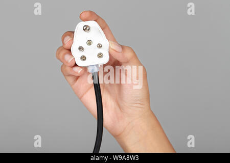 Close up of a person hand holding plug Stock Photo
