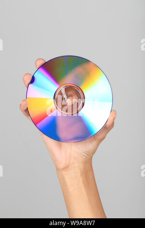 Close up of a person's hand showing a compact disc Stock Photo