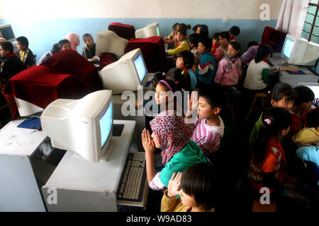 Hui ethnic students are seen during a computer lesson at the Heping Primary School in Linxia, northwest Chinas Gansu province, June 30, 2010.   Heping Stock Photo