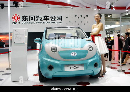 A model poses next to a Dongfeng I-Car concept at the 11th Beijing International Automotive Exhibition, known as Auto China 2010, in Beijing, China, 2 Stock Photo