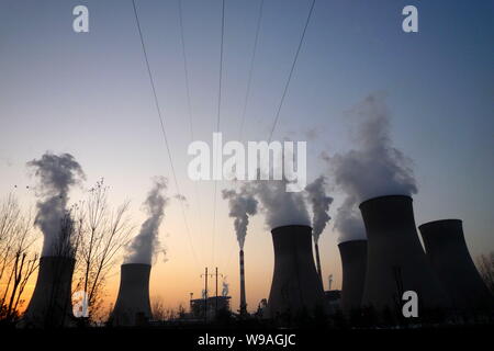 --FILE--Smoke and steam are seen emitted from chimneys and cooling towers at a coal-fired power plant in Shijiazhuang city, north Chinas Hebei provinc Stock Photo