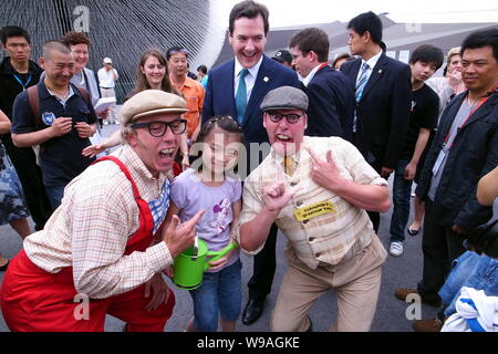 British Chancellor of the Exchequer George Osborne poses with British performers and Chinese visitors during his visit to the UK Pavilion in the Shang Stock Photo