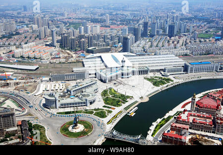 --FILE--Aerial view of the Tianjin Railway Station and clusters of modern office and residential apartment buildings in Tianjin, China, 2 July 2010. Stock Photo
