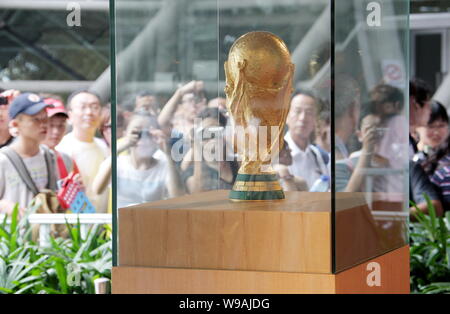 Visitors look at the FIFA World Cup Trophy (or Jules Rimet Cup) at the Spain Pavilion in the World Expo Park in Shanghai, China, 30 August 2010.   The Stock Photo