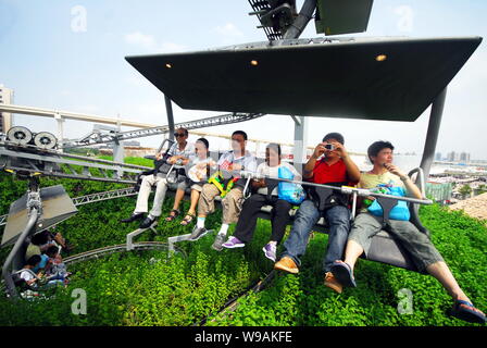 Visitors sit on the Titlis Mountain chair lifts in the Switzerland Pavilion in the World Expo Park in Shanghai, China, 20 July 2010.   The World Expo Stock Photo