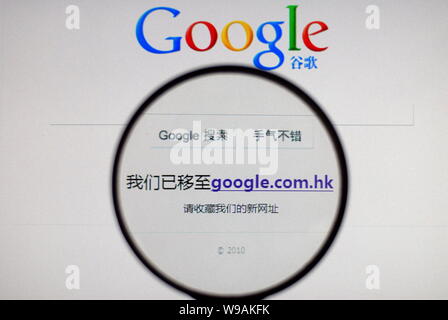 A Chinese Man Uses A Magnifier To Magnify The Notice Saying We