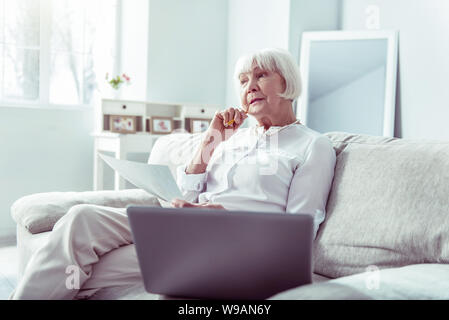 Retired artist feeling thoughtful having no ideas about new painting Stock Photo
