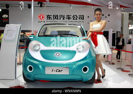 A model poses next to a Dongfeng I-Car concept at the 11th Beijing International Automotive Exhibition, known as Auto China 2010, in Beijing, China, 2 Stock Photo