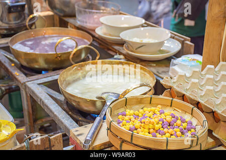 Thai dessert or Bua loi , Dumplings rice ball on bamboo tray and coconut milk. Stock Photo