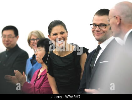 Victoria (center), Crown Princess of Sweden and her husband, Prince Daniel are seen at an opening ceremony of a fashion event in Beijing, China, Octob Stock Photo