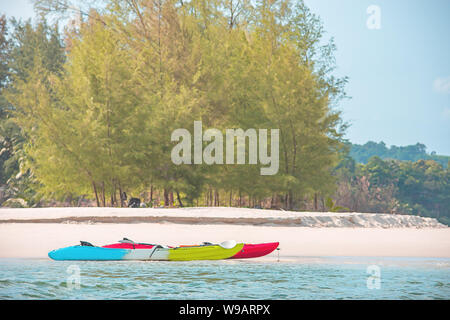 Kayaking on the sand of the sea background trees. Stock Photo