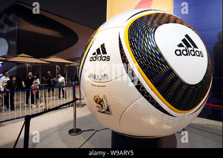 Visitors look at a big Adidas football for the 2010 FIFA World Cup inside the South Africa Pavilion in the World Expo Park in Shanghai, China, 19 May Stock Photo