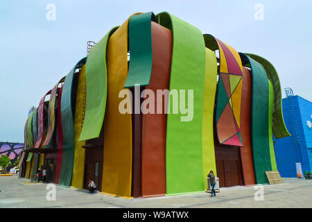 Visitors walk past the Angola Pavilion in the World Expo site in Shanghai, China, 4 May 2010. Stock Photo