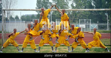 Young Chinese monks from Shaolin Temple Tagou Wushu School practise ...